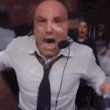 Man wearing a headset and tie expressing shock or surprise with mouth wide open.
